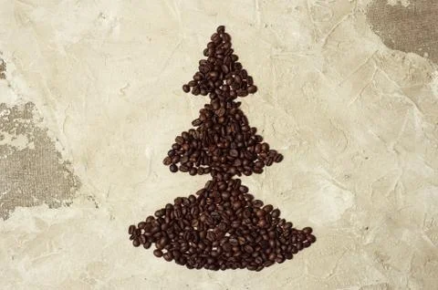 Coffee beans in heart shape on background fabrics of jute Stock Photos