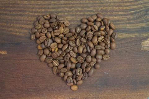 Coffee beans in heart shape wood background isolated Stock Photos