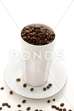 Coffee beans inside a white glass on white isolated background Stock Photos
