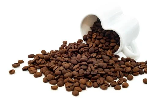 Coffee beans isolate. Coffee beans pouring out of a cup Stock Photos