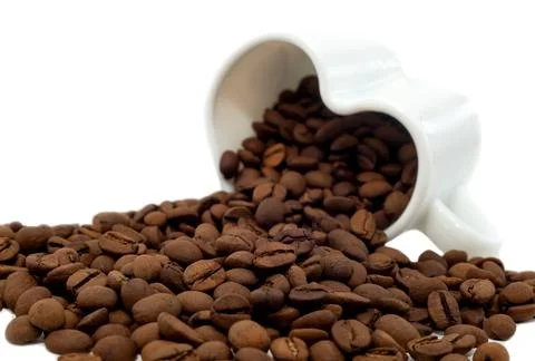Coffee beans isolate. Coffee beans pouring out of a cup in the shape Foto stock