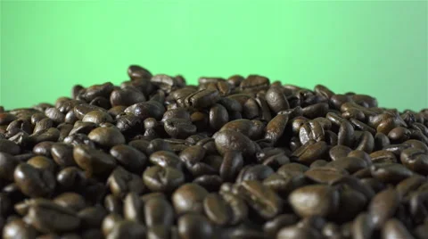 Coffee Beans isolated rotating on green background Stock Footage 62380007