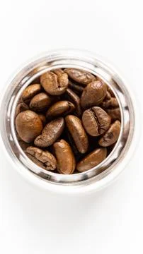 Coffee beans in a jar. Close up, isolated, white background. Stock Photos