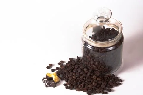Coffee beans in a jar on old kitchen table. Stock Photos
