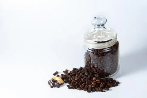 Coffee beans in a jar on old kitchen table. Stock Photos