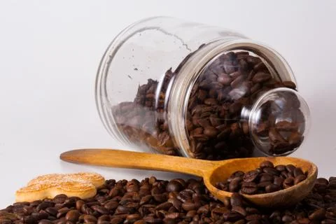 Coffee beans in a jar with a spoon Stock Photos