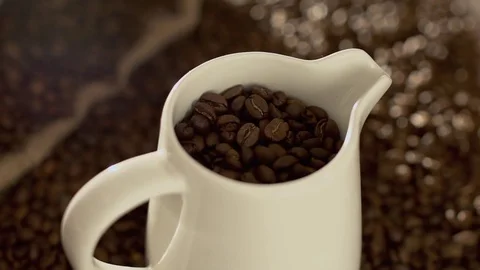 Coffee beans in jug in slow motion Stock Footage 76050907