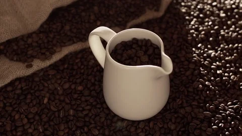 Coffee beans in jug in slow motion Stock Footage 76050991