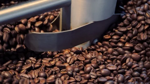 Coffee beans in a large coffee roaster. Close up. Видео 100883641