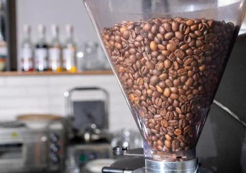 Coffee beans in machine, cafe backgeound. Horizontal Stock Photos