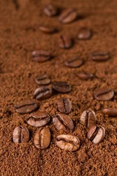 Coffee Beans macro on ground coffee background. Stock Photos