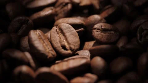 Coffee beans. Macro shot camera pans up and showing awesome roasted coffee beans Video stock 207909821