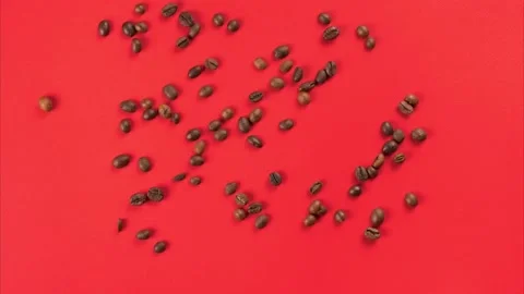 Coffee beans moving and forming heart shape, heartbeat on red studio background Stock Footage 223248043