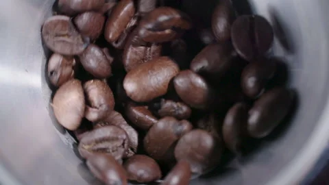 Coffee beans moving in grinder 2 Stock Footage 130574625