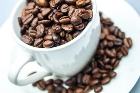 Coffee beans in a mug Stock Photos