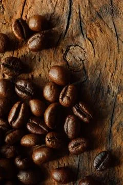 Coffee beans on the old board Stock Photos
