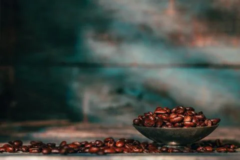 Coffee beans in old small silver with the rustic blue wooden background with Stock Photos