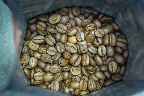 Coffee beans in open packaging coarsely. quality photo Stock Photos