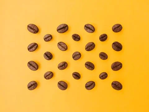 Coffee beans on an orange background. Stock Photos