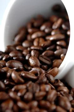 Coffee beans outside the cup Stock Photos