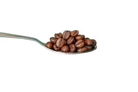Coffee beans piled on a spoon isolated against white background Stock Photos