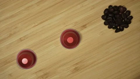 Coffee beans piles turning into capsules. Stop motion Stock Footage 214390668