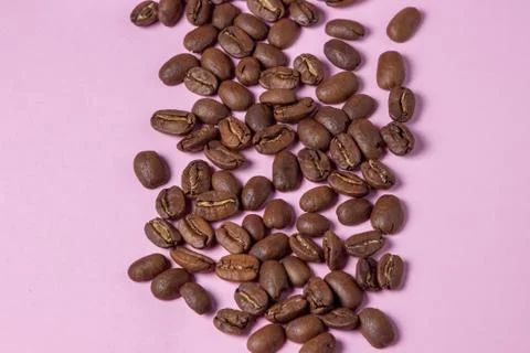 Coffee beans on a pink background. Stock Photos
