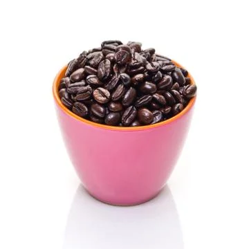Coffee beans in pink cup Stock Photos