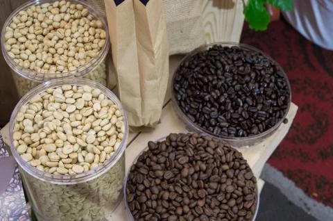 Coffee beans in plastic tray  on brown wooden background 스톡 사진