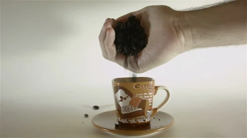 Coffee Beans Poured Into Small Coffee Cup Stock Footage 234936158