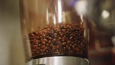 Coffee beans pouring down in machine. Stock Footage 76293173