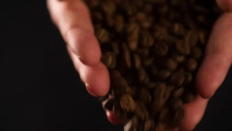 Coffee beans pouring from hands close up macro shot Slow Motion video Stock Footage 102618255
