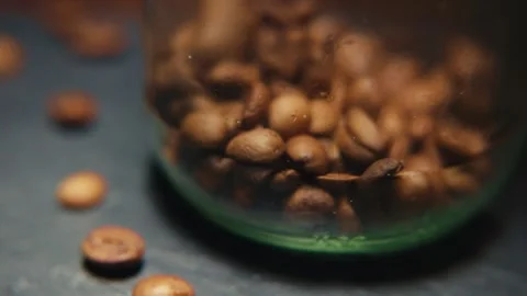 Coffee Beans Pouring Into Jar Close Up Macro Smokey Cinematic 4k Stock Footage 317472207