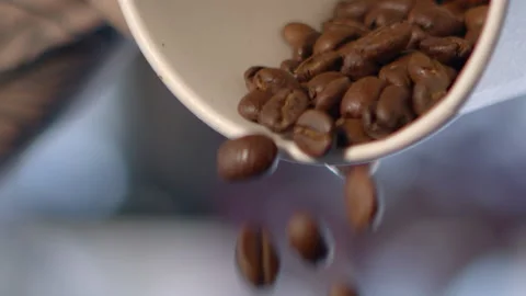 Coffee Beans Pouring out of Cup in Slow Motion Stock Footage 152745903