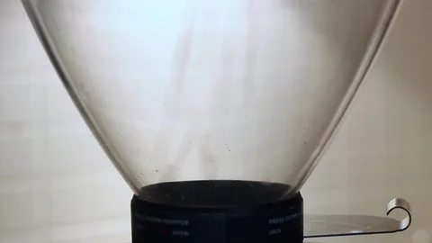 Coffee beans pouring from the pack to coffee grinder. silhouette Stock Footage 71669092