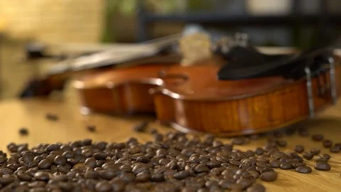 Coffee beans. Pured on the table next to the violin. 4K 스톡 동영상 102548835