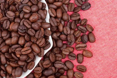 Coffee beans on red cloth background Stock Photos