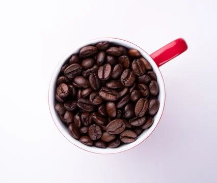 Coffee beans in a red cup on a white background Stock-Fotos