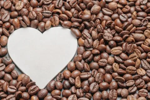 Coffee beans roasted as a background with space for text as a heart Фото
