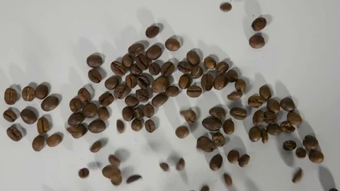 Coffee beans roasted coffee sprinkle on a white table Stock Footage 122727808