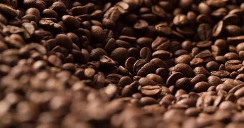 Coffee beans roasted rotating blurred background medium shot Stock Footage 98239540