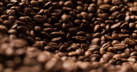 Coffee beans roasted rotating blurry background medium shot Stock Footage 98028256