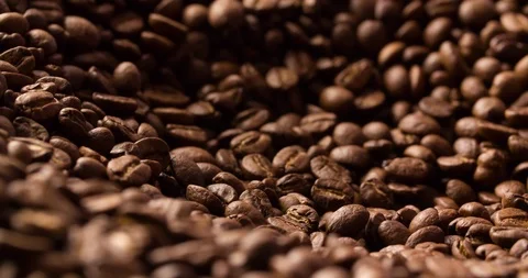 Coffee beans roasted rotating blurry background close up macro shot Stock Footage 98030127