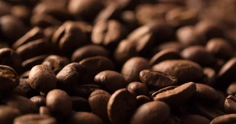 Coffee beans roasted rotating blurry background extremely close up Macro shot Stock Footage 98031180