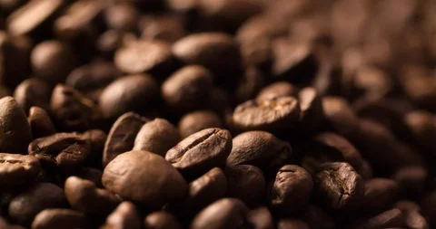 Coffee beans roasted rotating blurry background extremely close up Macro shot Stock Footage 98031399