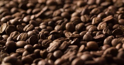 Coffee beans roasted rotating blurry background medium shot Stock Footage 98239349