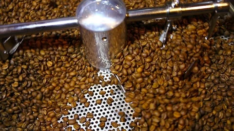 Coffee beans  is roasted in a spinning roaster. Video stock 114455295