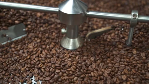 Coffee beans roasting and rotating inside working automatic equipment in modern Stock Footage 163816782