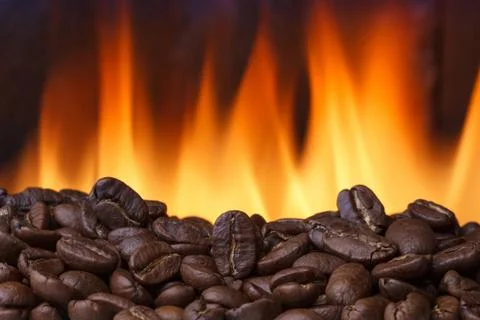 Coffee beans roasting with fire on background Stock-Fotos
