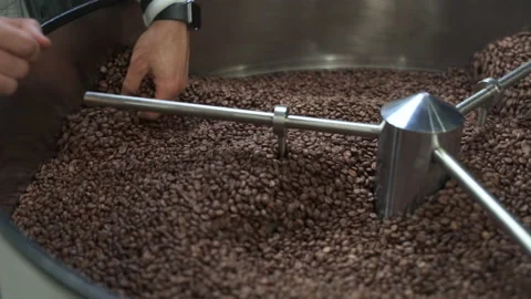 Coffee beans roasting inside equipment and worker working in modern factory Stock Footage 185511281